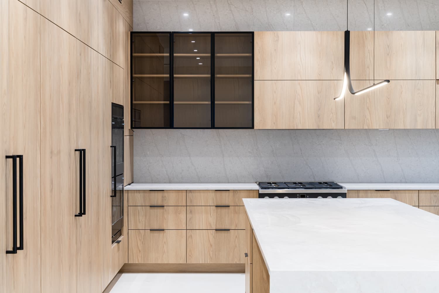 Light oak kitchen with stone countertops, angle 2