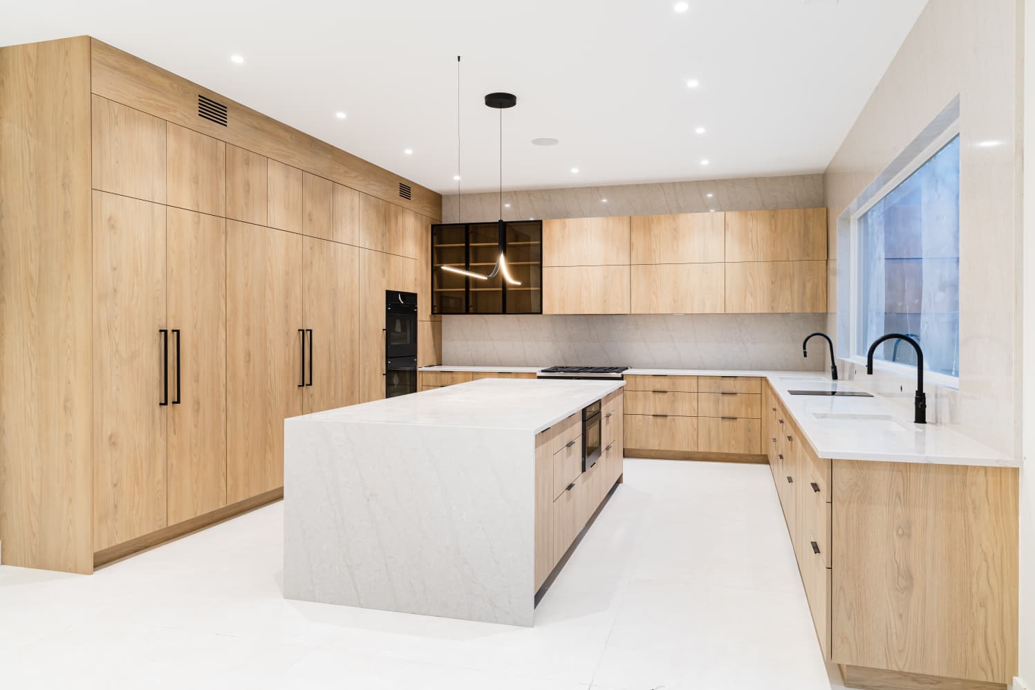 Light oak kitchen with stone countertops, angle 3